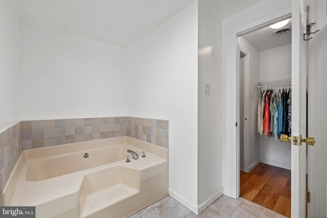 233 Kimble Rd, Berryville, VA 22611 - bathroom with a bath, a walk in closet, and tile patterned floors