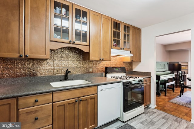 9039 Sligo Creek Pkwy Unit 102, Silver Spring, MD 20901 - kitchen featuring gas range, white dishwasher, a sink, and dark countertops