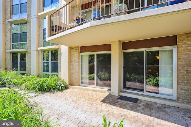 9039 Sligo Creek Pkwy Unit 102, Silver Spring, MD 20901 - view of exterior entry featuring a balcony and brick siding