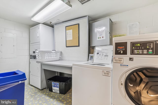 9039 Sligo Creek Pkwy Unit 102, Silver Spring, MD 20901 - communal laundry room with estacked washer and dryer, concrete block wall, and independent washer and dryer