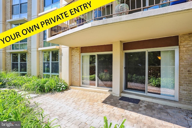 9039 Sligo Creek Pkwy Unit 102, Silver Spring, MD 20901 - view of exterior entry with a balcony and brick siding