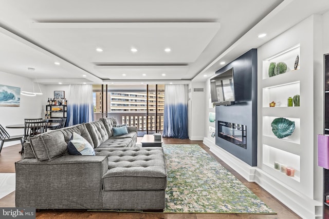 6101 Edsall Rd Unit 1111, Alexandria, VA 22304 - living room featuring a glass covered fireplace, wood finished floors, recessed lighting, and a tray ceiling