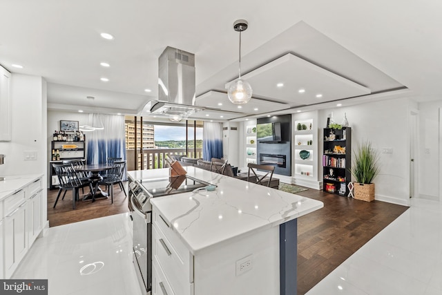 6101 Edsall Rd Unit 1111, Alexandria, VA 22304 - kitchen with stainless steel range with electric stovetop, white cabinetry, open floor plan, a kitchen island, and recessed lighting