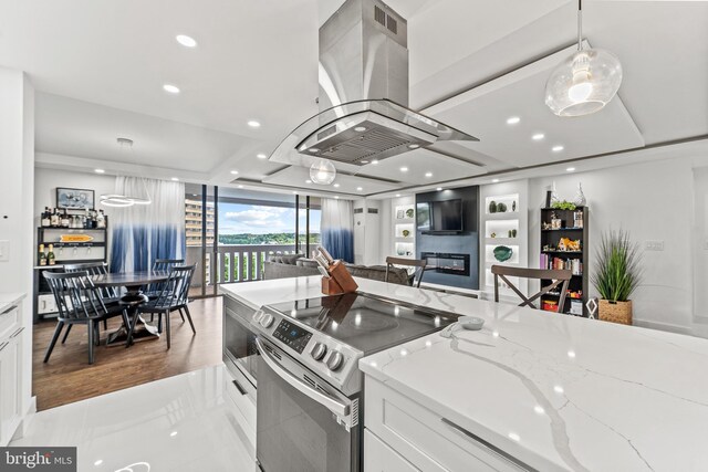6101 Edsall Rd Unit 1111, Alexandria, VA 22304 - kitchen featuring stainless steel electric stove, island exhaust hood, white cabinetry, light stone counters, and recessed lighting