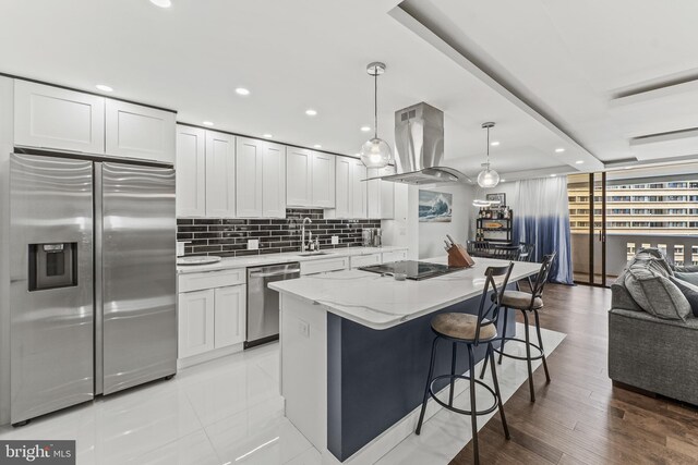 6101 Edsall Rd Unit 1111, Alexandria, VA 22304 - kitchen with stainless steel appliances, island exhaust hood, tasteful backsplash, white cabinets, and a breakfast bar