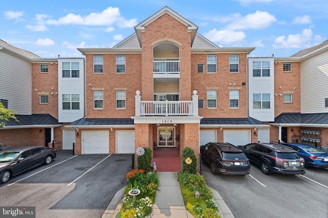 1412 Wigeon Way Unit 204, Gambrills, MD 21054 - view of property featuring an attached garage and driveway