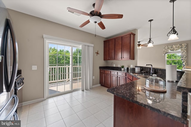 1412 Wigeon Way Unit 204, Gambrills, MD 21054 - kitchen featuring ceiling fan, appliances with stainless steel finishes, a peninsula, pendant lighting, and dark stone counters