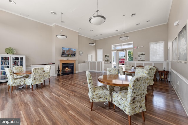 1412 Wigeon Way Unit 204, Gambrills, MD 21054 - dining space featuring crown molding, a high ceiling, wood finished floors, and a warm lit fireplace
