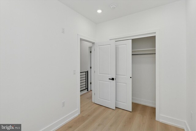 1910 E Atlantic St, Philadelphia, PA 19134 - unfurnished bedroom with light wood finished floors, baseboards, a closet, and recessed lighting