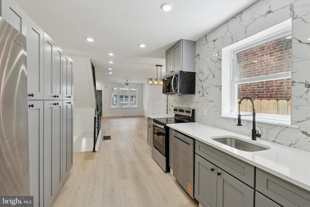 1910 E Atlantic St, Philadelphia, PA 19134 - kitchen featuring a sink, appliances with stainless steel finishes, gray cabinetry, recessed lighting, and decorative backsplash