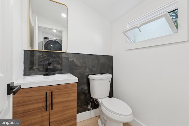 1910 E Atlantic St, Philadelphia, PA 19134 - bathroom featuring toilet, vanity, a skylight, and lofted ceiling