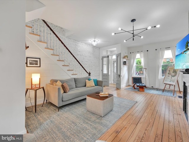 142 E New St, Lancaster, PA 17602 - living area with stairs, hardwood / wood-style floors, a chandelier, and baseboards