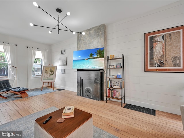 142 E New St, Lancaster, PA 17602 - living area featuring hardwood / wood-style floors, a chandelier, and wood walls