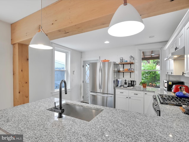142 E New St, Lancaster, PA 17602 - kitchen featuring appliances with stainless steel finishes, a sink, under cabinet range hood, light stone countertops, and open shelves