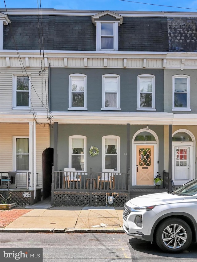 142 E New St, Lancaster, PA 17602 - view of property featuring covered porch, mansard roof, and a shingled roof