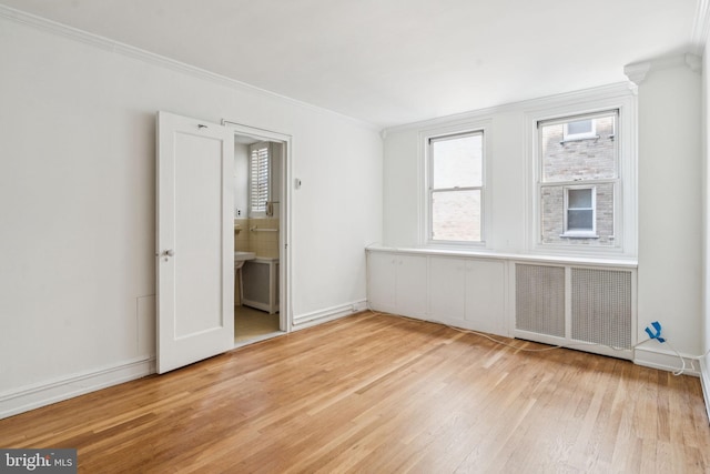 1901 Walnut St Unit 16E, Philadelphia, PA 19103 - unfurnished room with light wood-style floors, crown molding, radiator, and baseboards