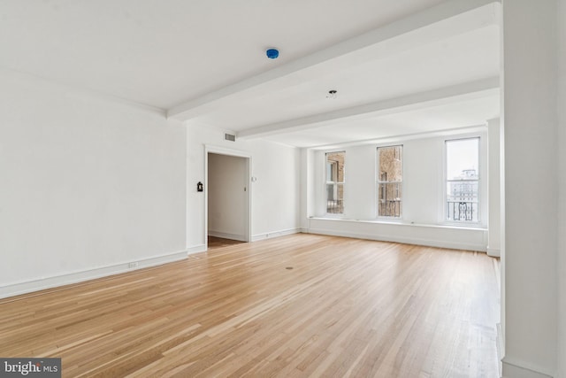 1901 Walnut St Unit 16E, Philadelphia, PA 19103 - spare room featuring light wood-type flooring, beamed ceiling, and baseboards