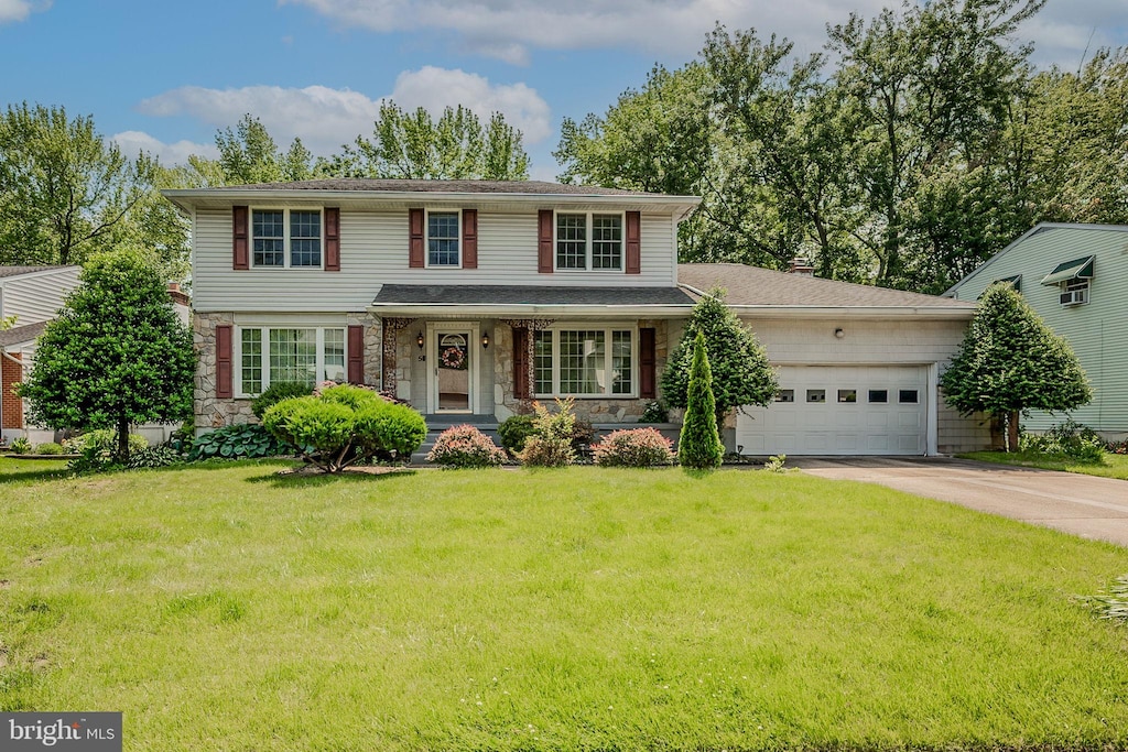 5 Sunnybrae Ct, Wilmington, DE 19810 - traditional-style house with concrete driveway, an attached garage, stone siding, a front lawn, and covered porch