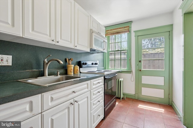 340 W Durham St, Philadelphia, PA 19119 - kitchen featuring electric range, white microwave, radiator, a sink, and dark countertops