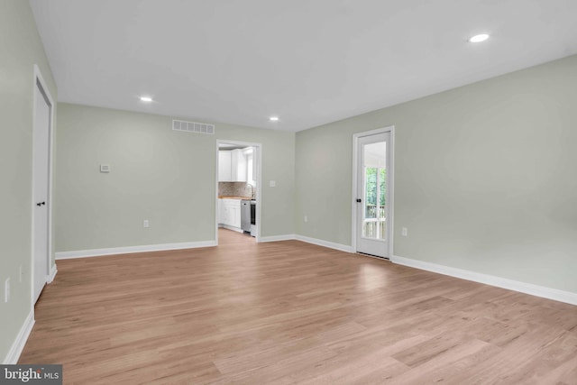 318 Mayfield Ct, Westminster, MD 21158 - unfurnished living room with baseboards, light wood-style floors, recessed lighting, and a sink