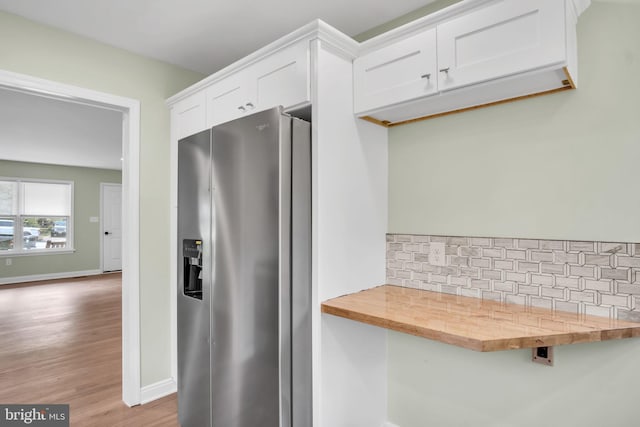 318 Mayfield Ct, Westminster, MD 21158 - kitchen featuring stainless steel fridge, backsplash, butcher block countertops, white cabinets, and baseboards