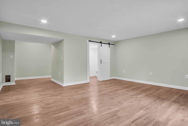 318 Mayfield Ct, Westminster, MD 21158 - unfurnished room with a barn door, baseboards, light wood finished floors, and recessed lighting