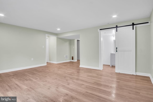 318 Mayfield Ct, Westminster, MD 21158 - below grade area featuring a barn door, light wood-style flooring, recessed lighting, and baseboards