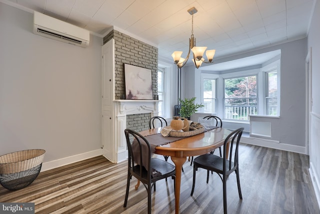 143 Hanover St, Glen Rock, PA 17327 - dining area featuring an AC wall unit, wood finished floors, baseboards, and a chandelier
