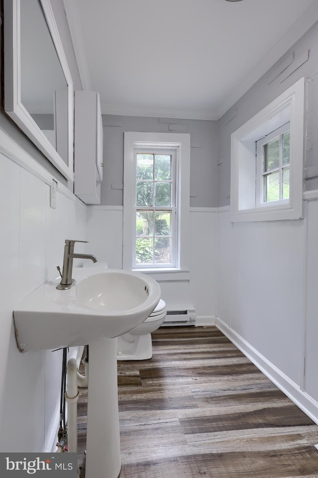 143 Hanover St, Glen Rock, PA 17327 - bathroom featuring baseboard heating, toilet, wood finished floors, and wainscoting