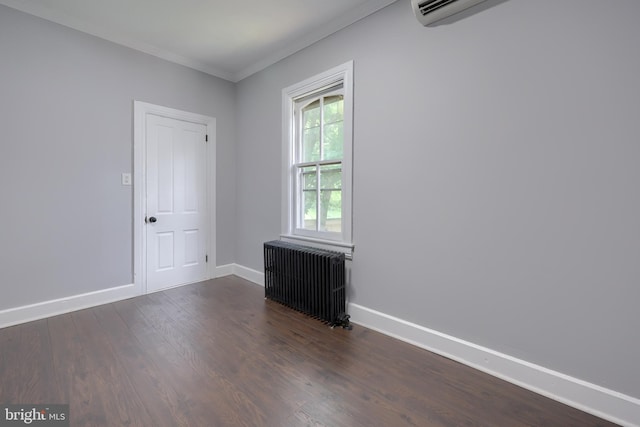 143 Hanover St, Glen Rock, PA 17327 - spare room with radiator heating unit, crown molding, dark wood-type flooring, and baseboards
