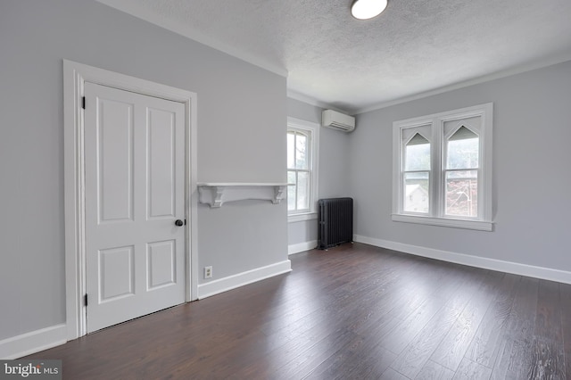 143 Hanover St, Glen Rock, PA 17327 - spare room with radiator heating unit, a textured ceiling, a wall mounted AC, dark wood finished floors, and baseboards