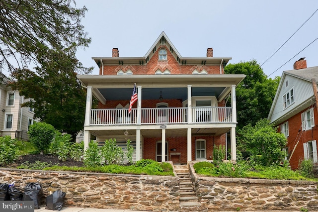143 Hanover St, Glen Rock, PA 17327 - view of front of property featuring brick siding, a balcony, a chimney, and covered porch