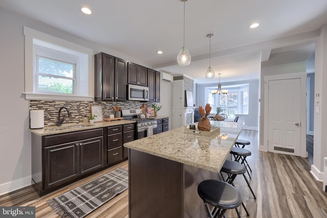 143 Hanover St, Glen Rock, PA 17327 - kitchen featuring appliances with stainless steel finishes, a breakfast bar area, baseboards, dark brown cabinetry, and recessed lighting