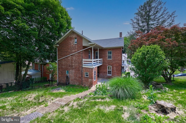 143 Hanover St, Glen Rock, PA 17327 - back of house with brick siding, a chimney, and a balcony