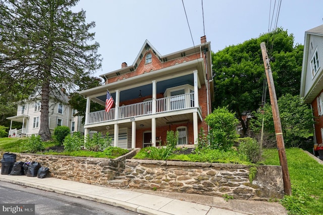 143 Hanover St, Glen Rock, PA 17327 - view of front of home with a balcony, brick siding, and a chimney