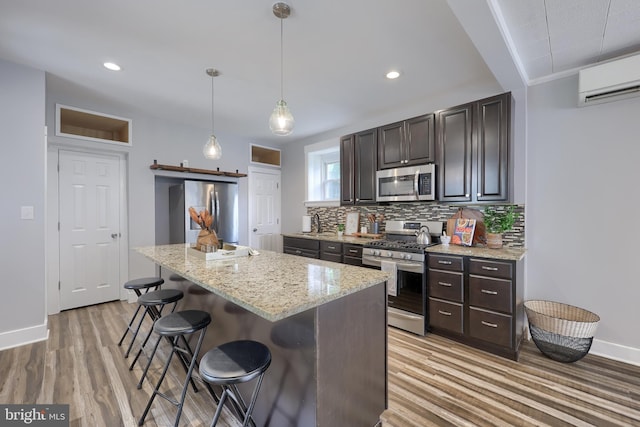 143 Hanover St, Glen Rock, PA 17327 - kitchen featuring stainless steel appliances, backsplash, baseboards, a kitchen bar, and dark brown cabinetry