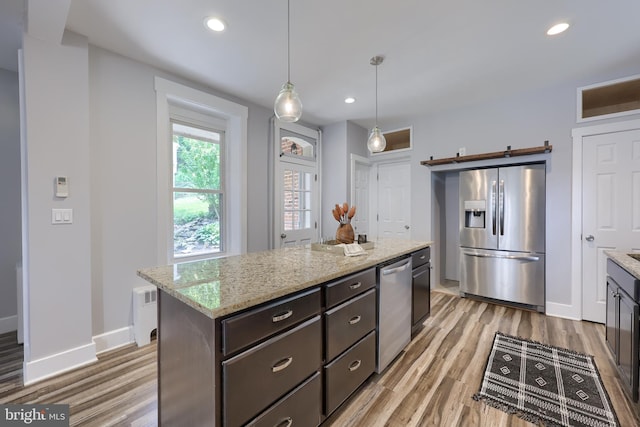 143 Hanover St, Glen Rock, PA 17327 - kitchen featuring stainless steel appliances, a barn door, light wood-style floors, baseboards, and recessed lighting