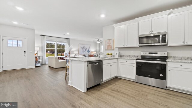 7 Florence Sarah Ln, Lexington City, VA 24450 - kitchen with stainless steel appliances, a sink, white cabinetry, a peninsula, and recessed lighting