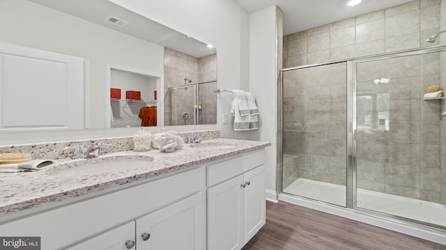 7 Florence Sarah Ln, Lexington City, VA 24450 - full bathroom featuring double vanity, a shower stall, a spacious closet, and wood finished floors