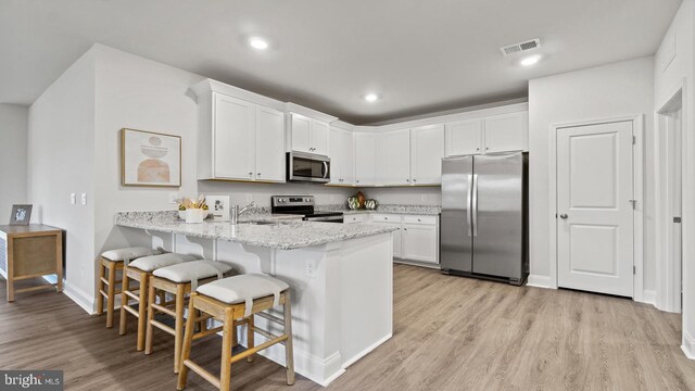 7 Florence Sarah Ln, Lexington City, VA 24450 - kitchen featuring appliances with stainless steel finishes, a peninsula, light wood-type flooring, white cabinetry, and recessed lighting