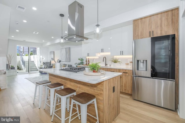 5403 5th St NW Unit 1, Washington, DC 20011 - kitchen with appliances with stainless steel finishes, island range hood, modern cabinets, a center island, and recessed lighting