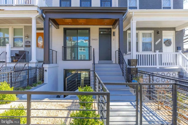 5403 5th St NW Unit 1, Washington, DC 20011 - view of exterior entry featuring brick siding, a porch, and mansard roof