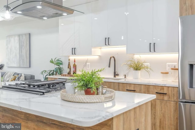 5403 5th St NW Unit 1, Washington, DC 20011 - kitchen featuring modern cabinets, ventilation hood, appliances with stainless steel finishes, white cabinetry, and light stone counters