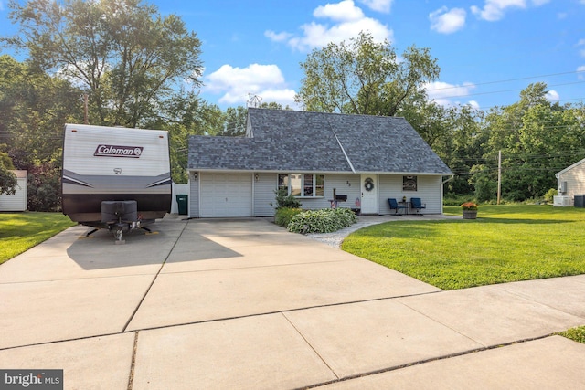 35 Long Loop Rd, Levittown, PA 19056 - view of front facade featuring concrete driveway, a front lawn, a garage, covered porch, and a shingled roof
