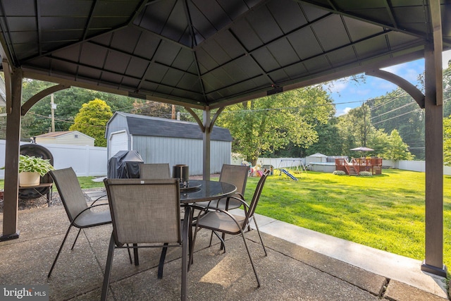 35 Long Loop Rd, Levittown, PA 19056 - view of patio featuring a grill, outdoor dining space, a gazebo, a playground, and a storage unit