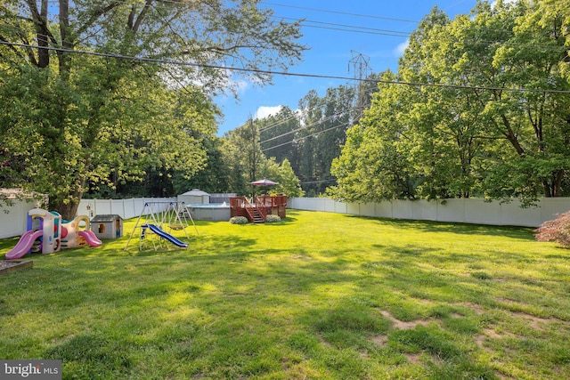 35 Long Loop Rd, Levittown, PA 19056 - fenced backyard with a playground and a deck