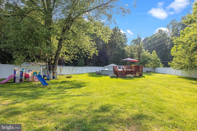 35 Long Loop Rd, Levittown, PA 19056 - fenced backyard featuring a playground and a wooden deck