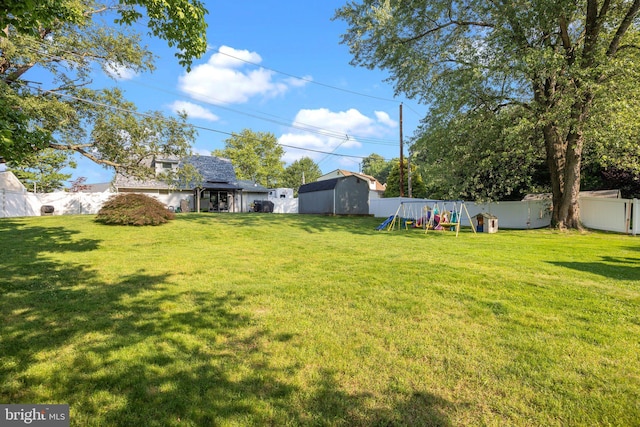 35 Long Loop Rd, Levittown, PA 19056 - fenced backyard featuring a playground and a storage shed