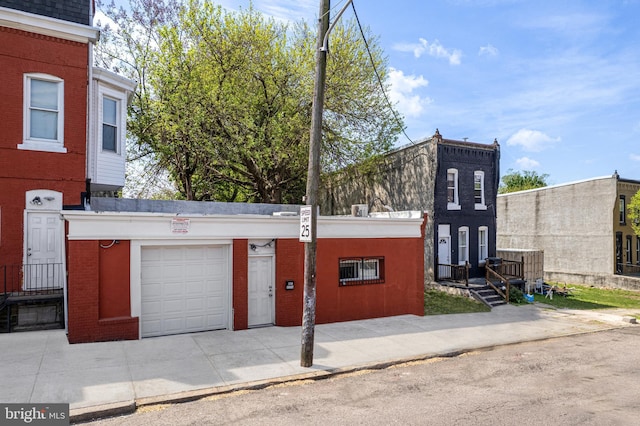 1718 N 55th St, Philadelphia, PA 19131 - view of property featuring a garage and concrete driveway