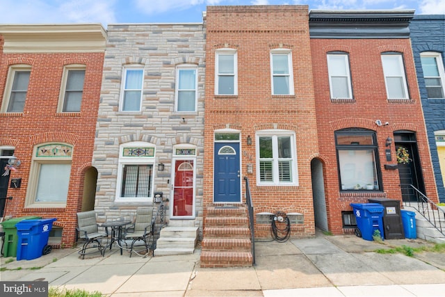 816 S Milton Ave, Baltimore, MD 21224 - view of property featuring entry steps, stone siding, and brick siding